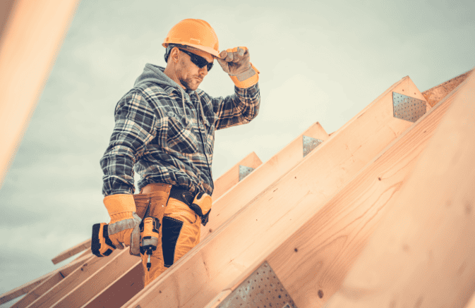 How Roofing Companies Get Leads: Top Channels for Consistent Call Volume Roofing contractor inspecting roof framing during a home construction project